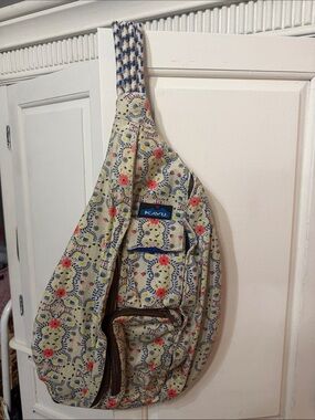 Kavu cream floral crossbody sling with red and blue accents